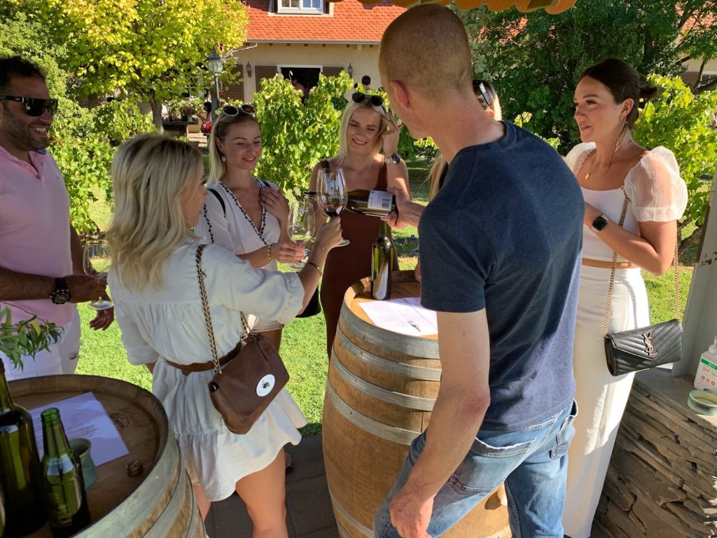 Barossa Valley winery tour, tasting wines outdoors with an Oak barrel. copy