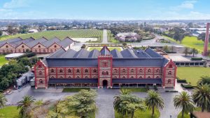 Aerial view of Château Tanunda winery with vineyards and historic building.