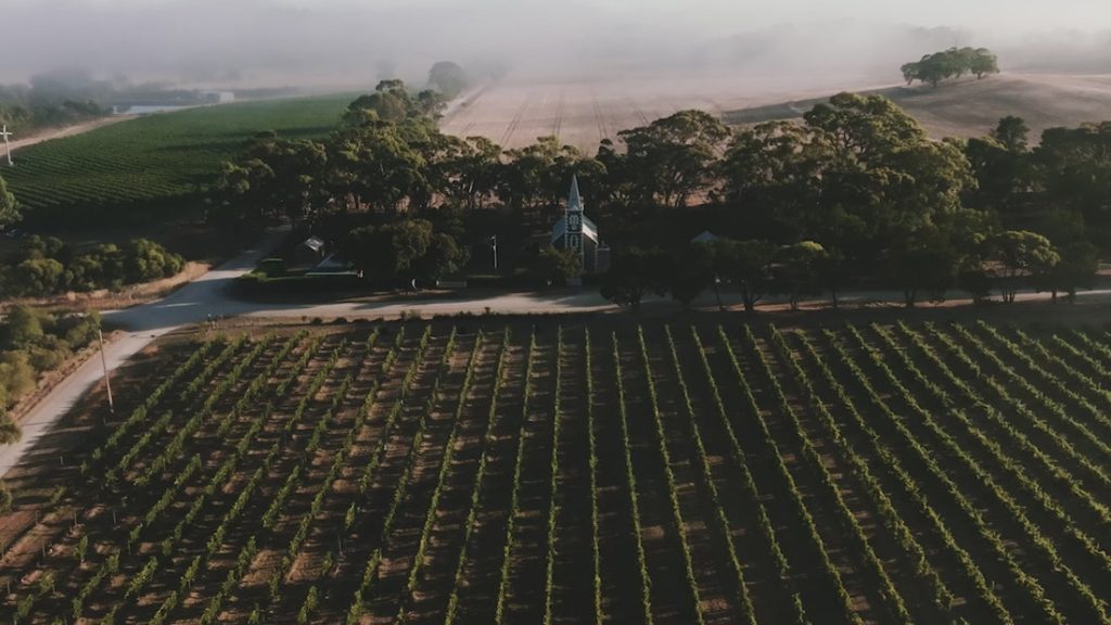 Aerial view of vineyards and a historic building near Henschke Cellars.